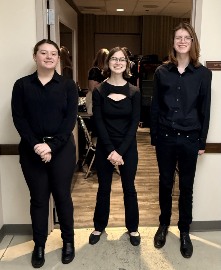 Trio of young musicians off stage.