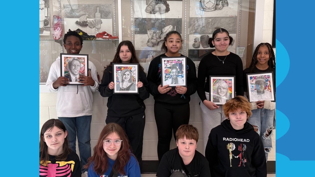 Nine children are posing for a photograph. Each holds a picture frame featuring a portrait of a person.