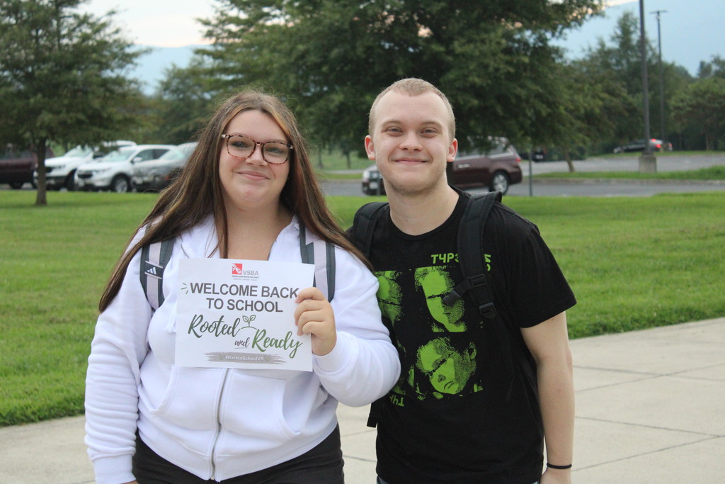 boy and girl posing for first day pictures