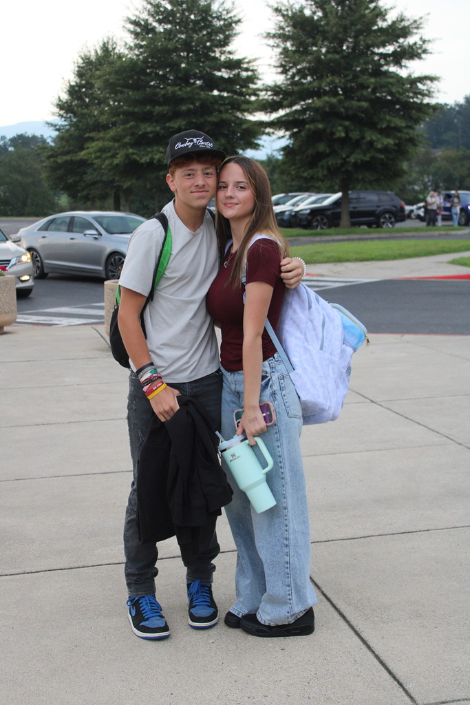 couple posing for first day of school picture