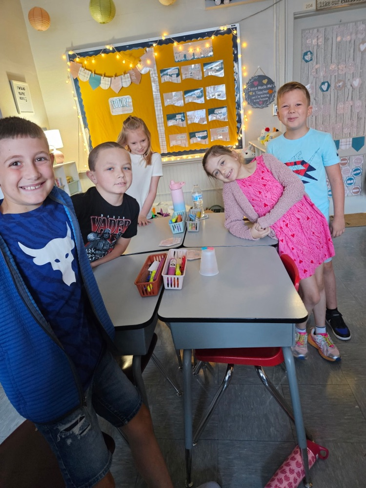     Five third graders pose together after completing the “Save Fred” STEM challenge.