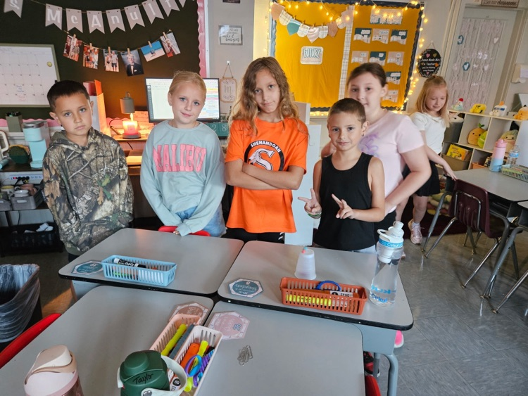     A group of third graders stands beside their completed “Save Fred” STEM activity.