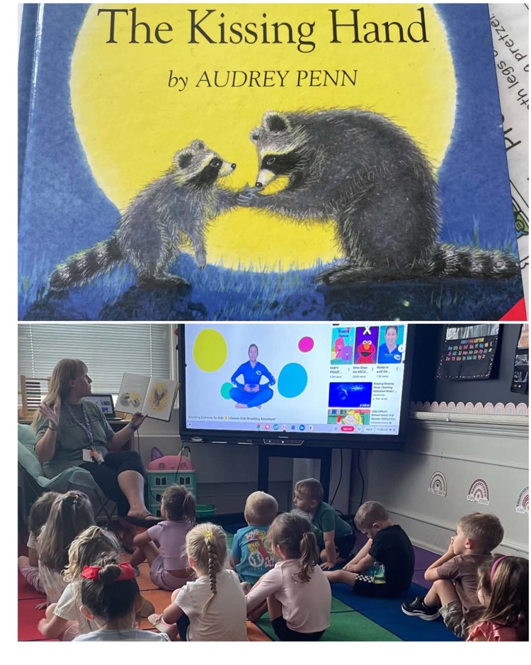 Students listen as their teacher reads The Kissing Hand by Audrey Penn