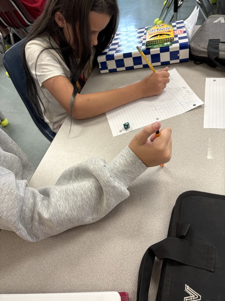 5th graders playing a math game with dice