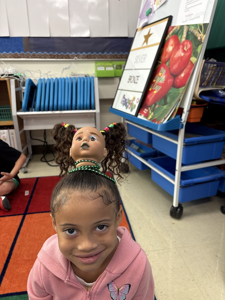 little girl with doll head on head