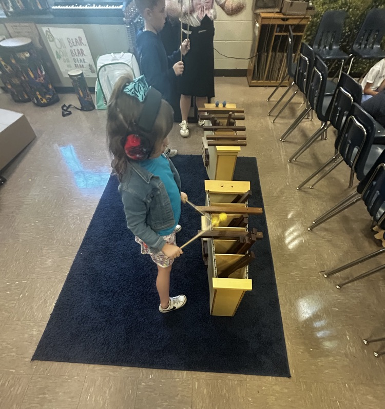 Second grade students playing instruments in music class.