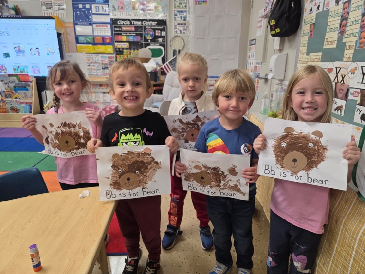 kids showing off their heart art