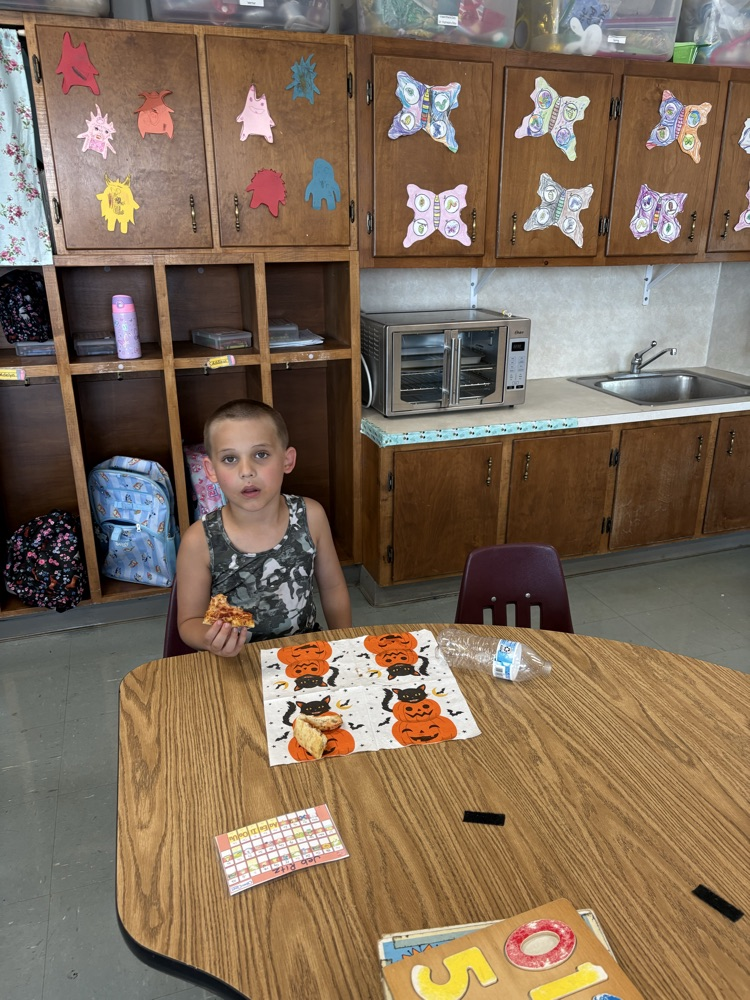 kindergartener enjoying pizza