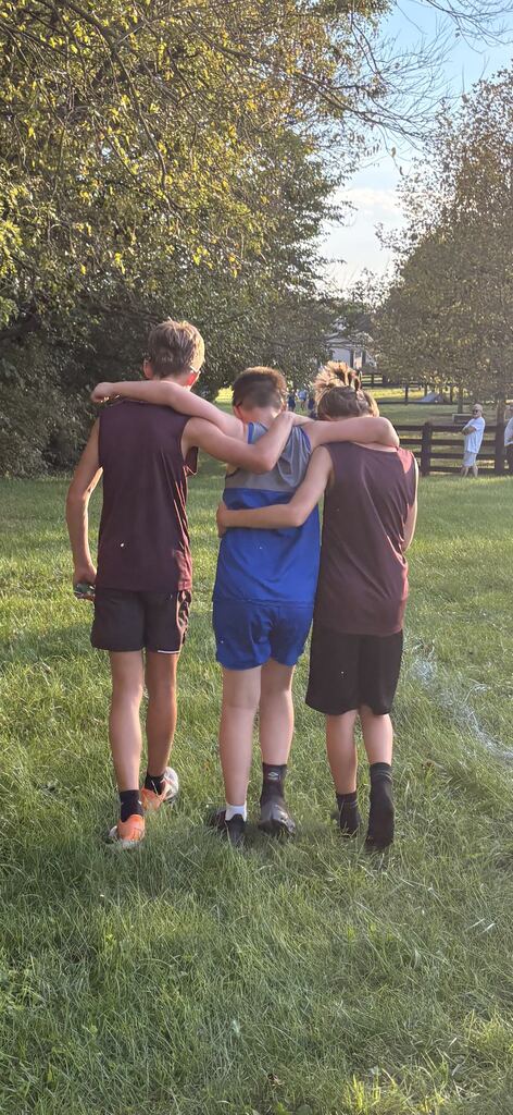 Luray Middle School XC runners helping an opponent