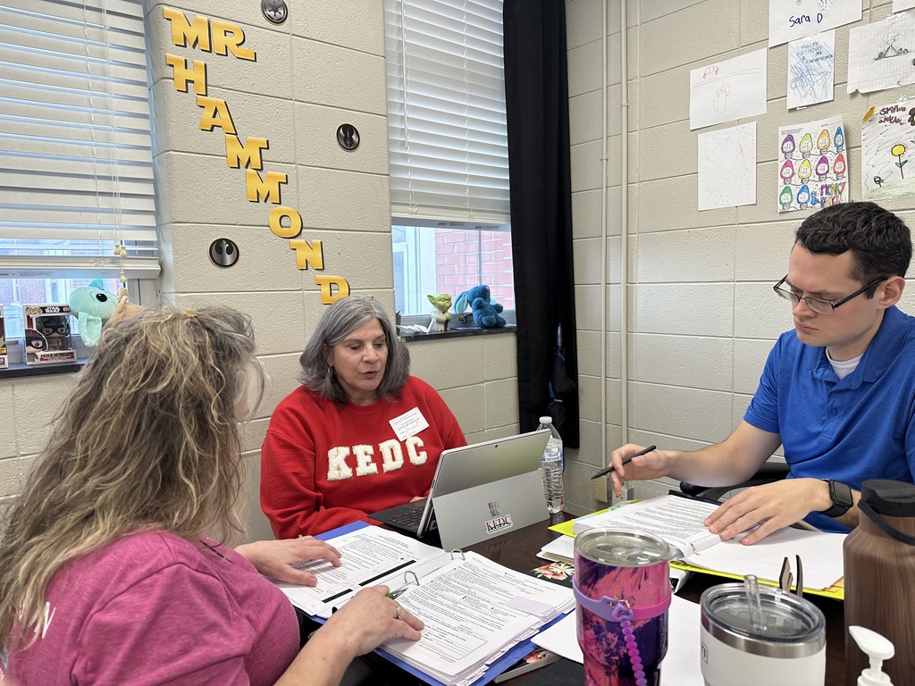 Staff reviewing due process folders with KEDC consultants