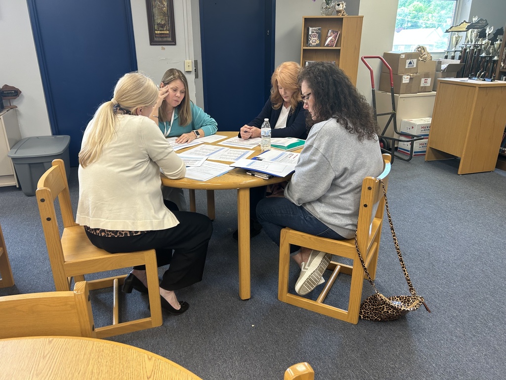 Team members reviewing sections of a document