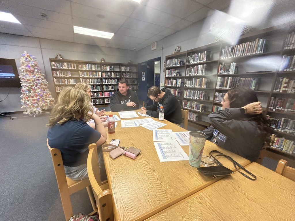 Team members discussing and reviewing sections of a document