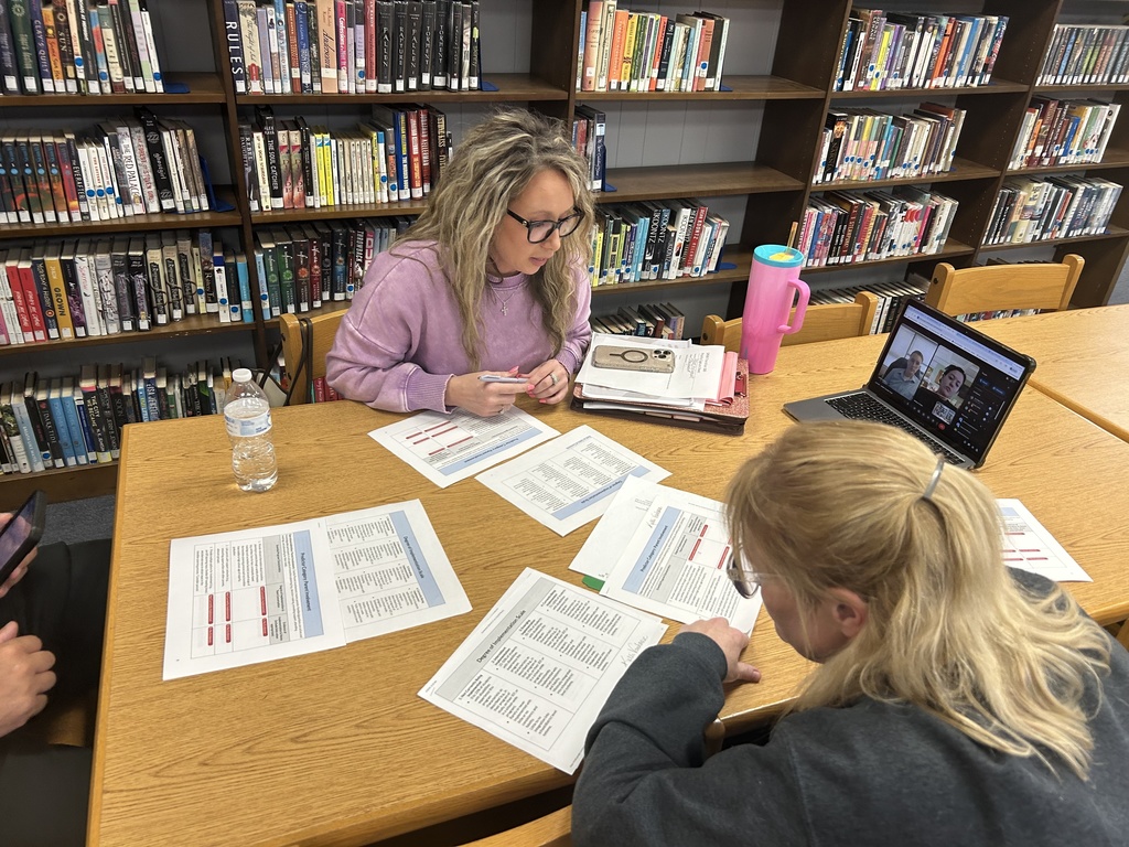 Team members reviewing sections of a document