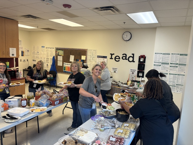 group in room taking burgers from buffet