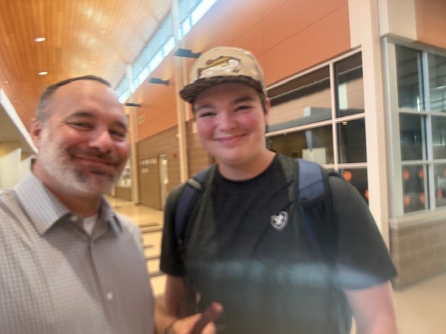 Mr. Kerr hanging with a student