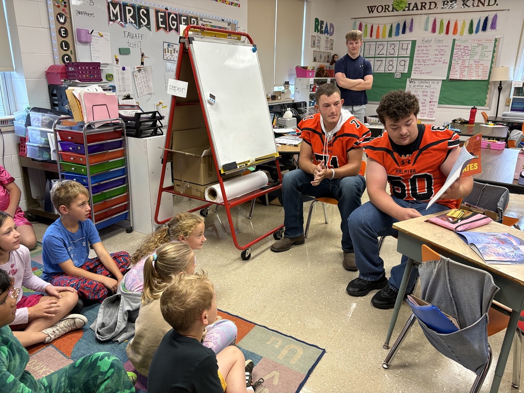 Football reading to the Panther classes