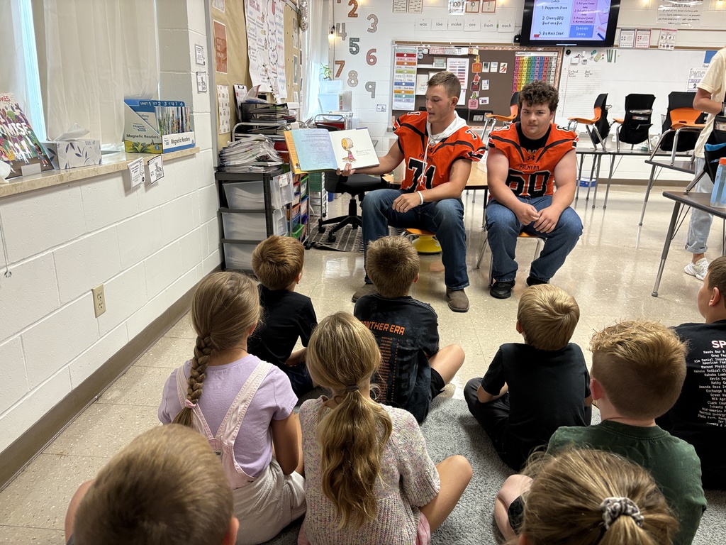Football reading to the Panther classes