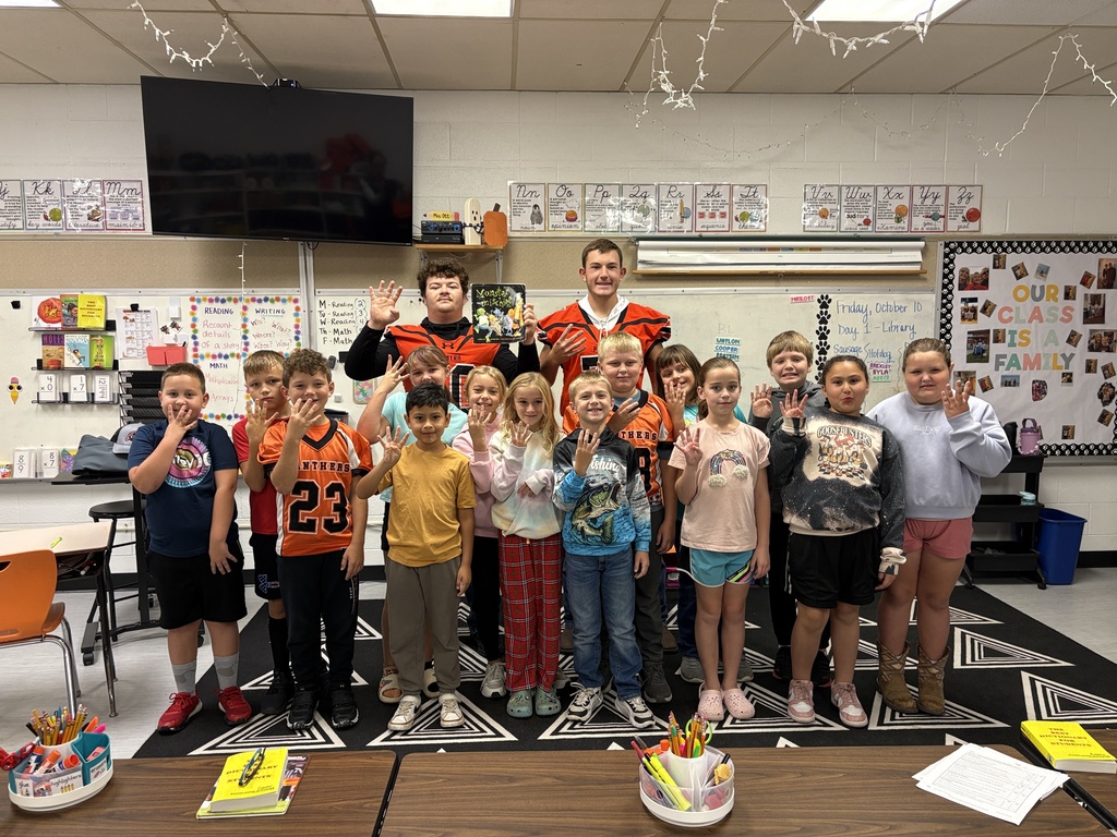 Football players read to 3rd grade class at PES