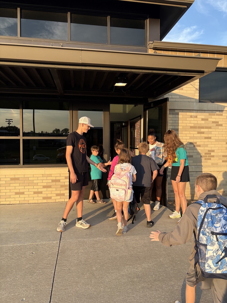 PHS athletes greeting kids at PES morning dropoff