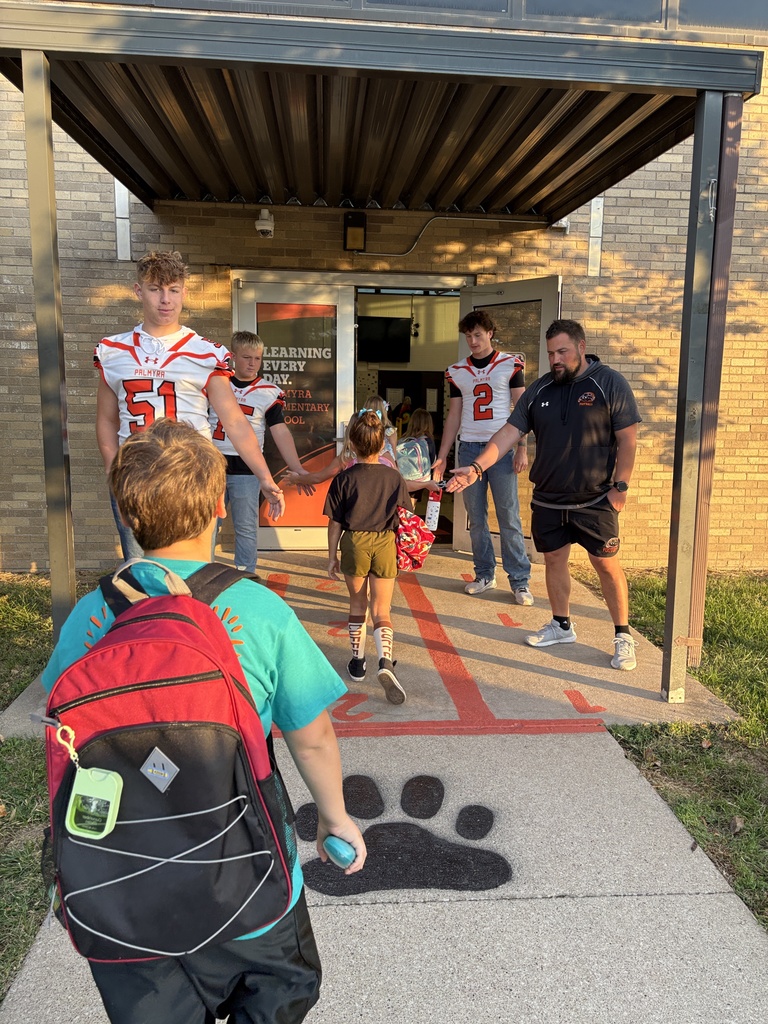 PHS Football greeting student on Homecoming morning