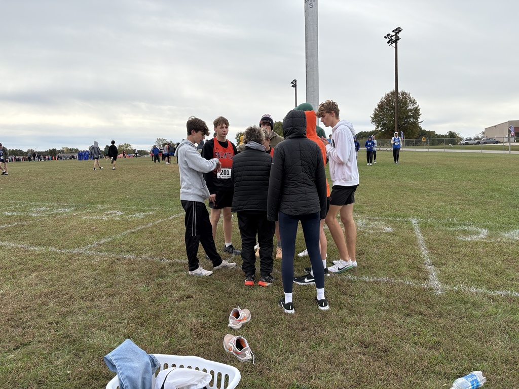 cross country team huddle before the race