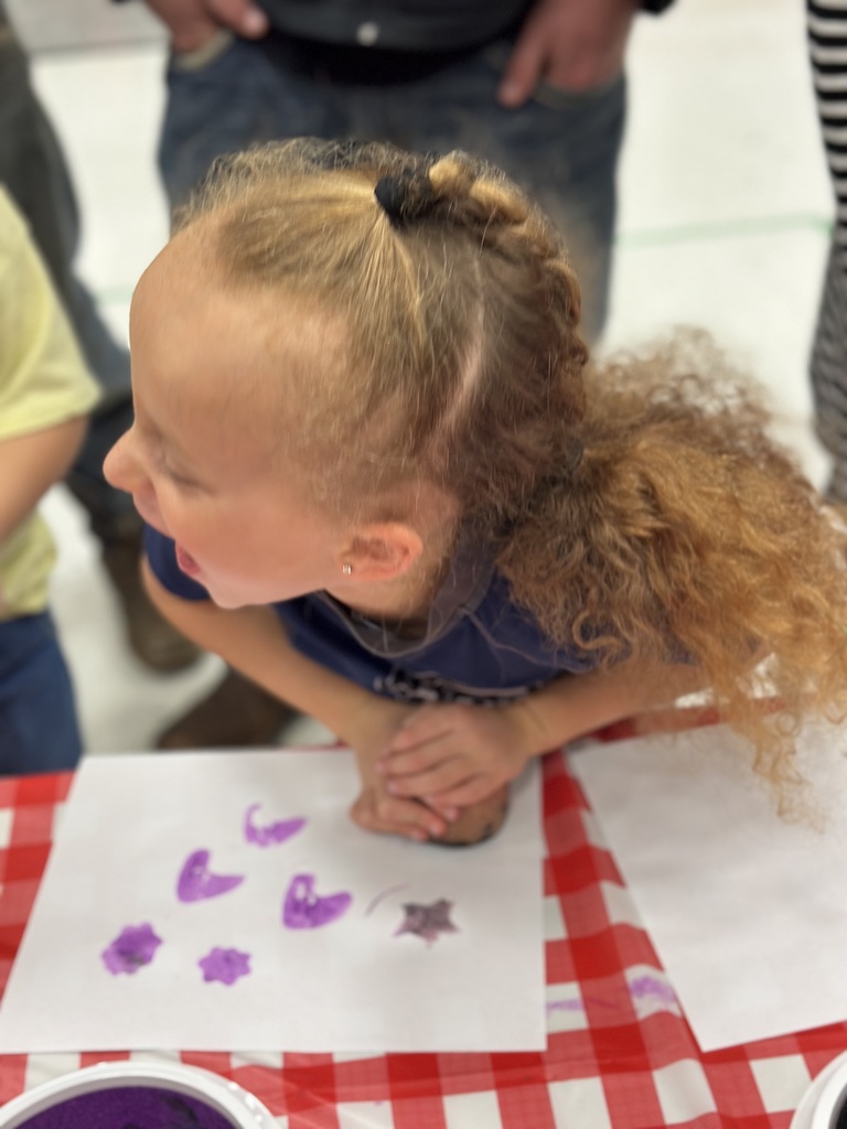 1st grade students and families at open house showing off their projects