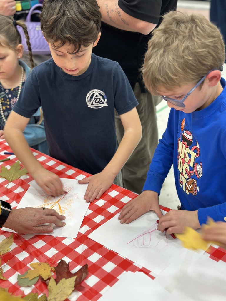 1st grade students and families at open house showing off their projects