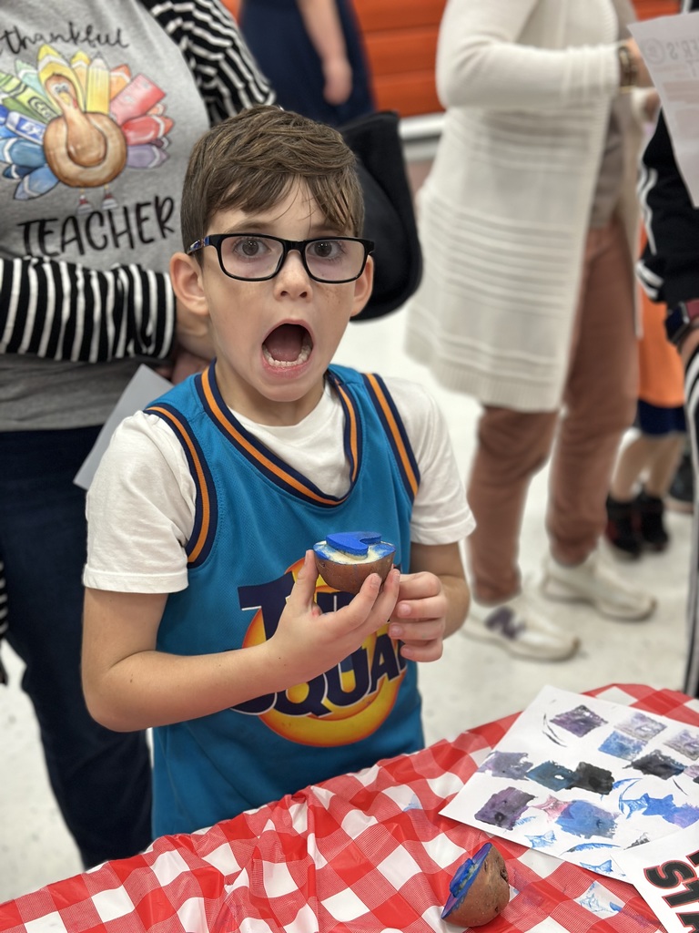 1st grade students and families at open house showing off their projects