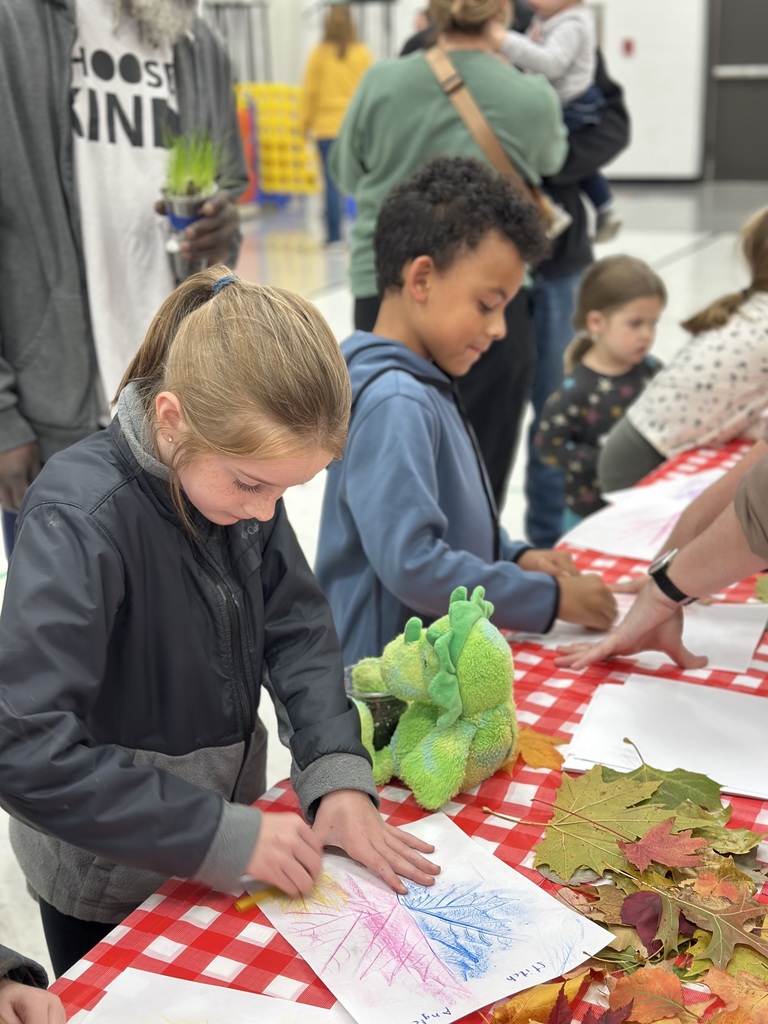 1st grade students and families at open house showing off their projects