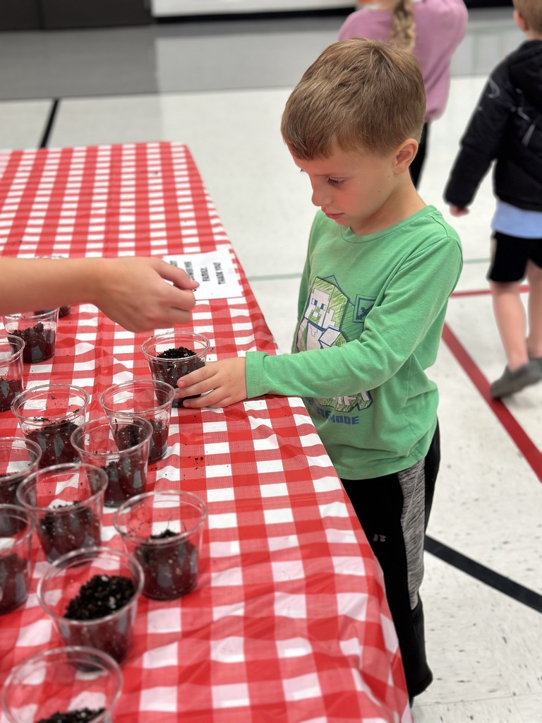 1st grade students and families at open house showing off their projects