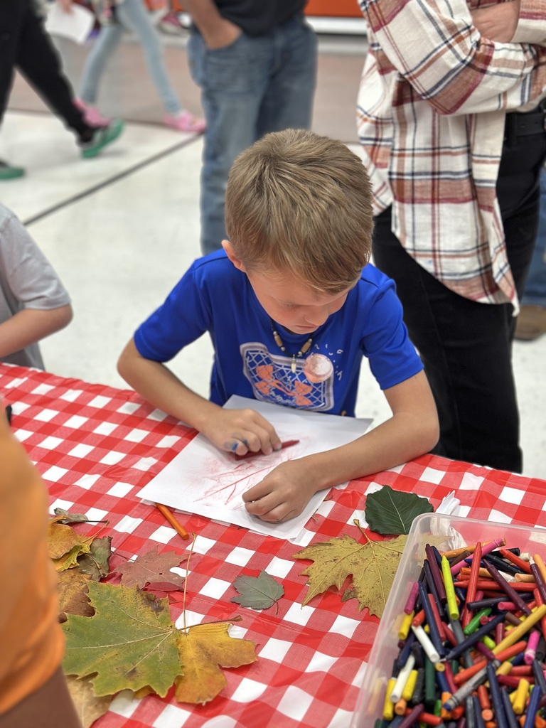 1st grade students and families at open house showing off their projects