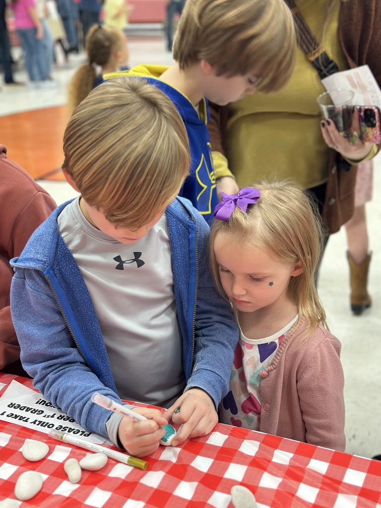 1st grade students and families at open house showing off their projects