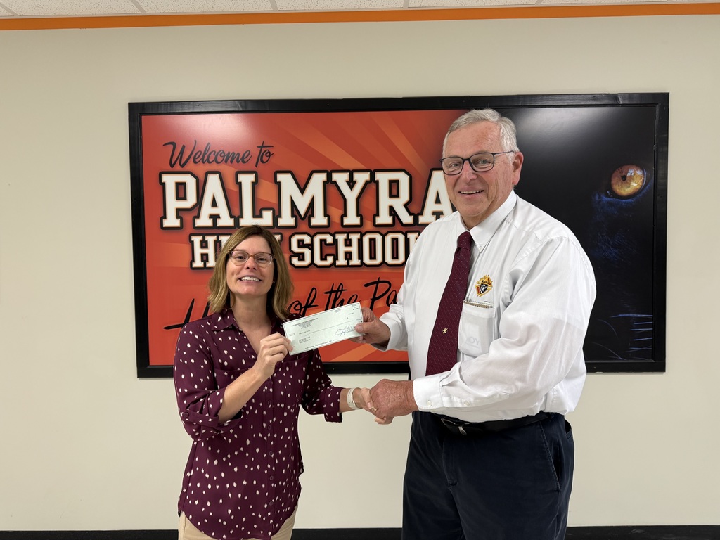 Mrs Cissna accepts donation from Knights of Columbus representative, David Hastings