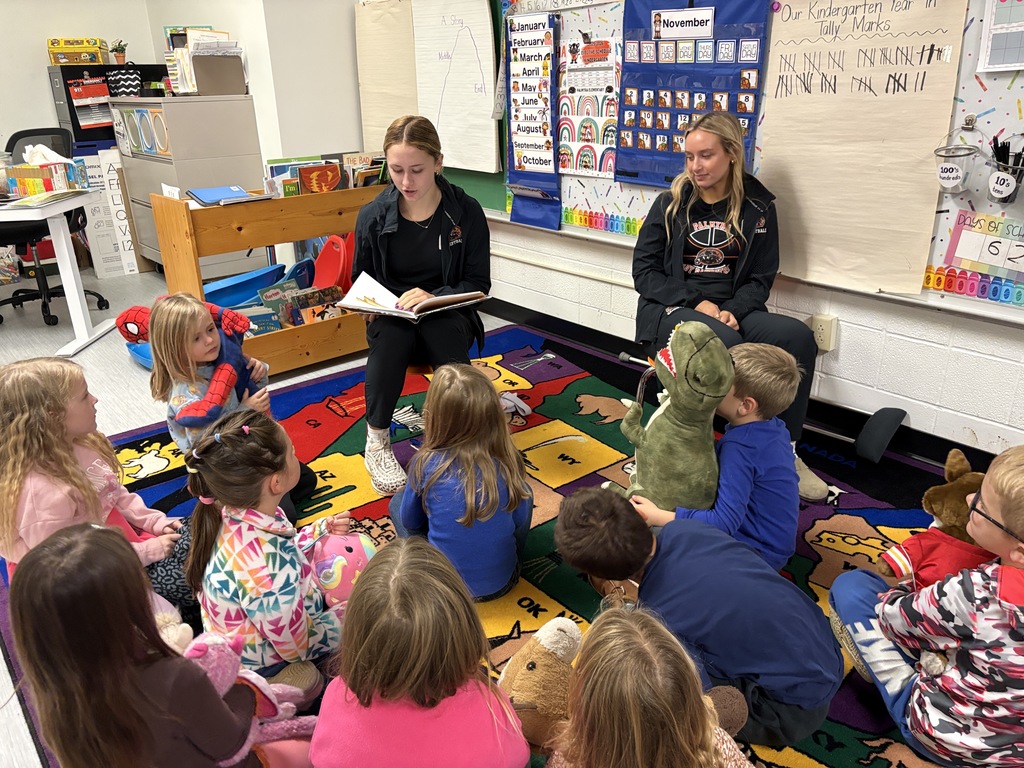 PHS baskeball reads to students at PES