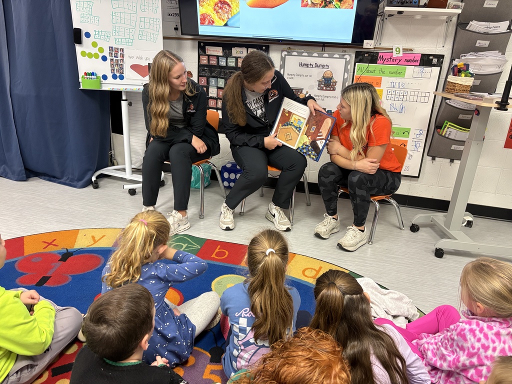PHS baskeball reads to students at PES