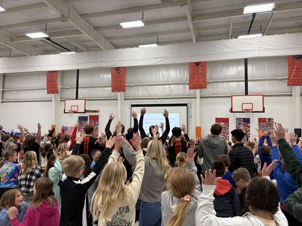 PHS baskeball in morning assembly with students at PES