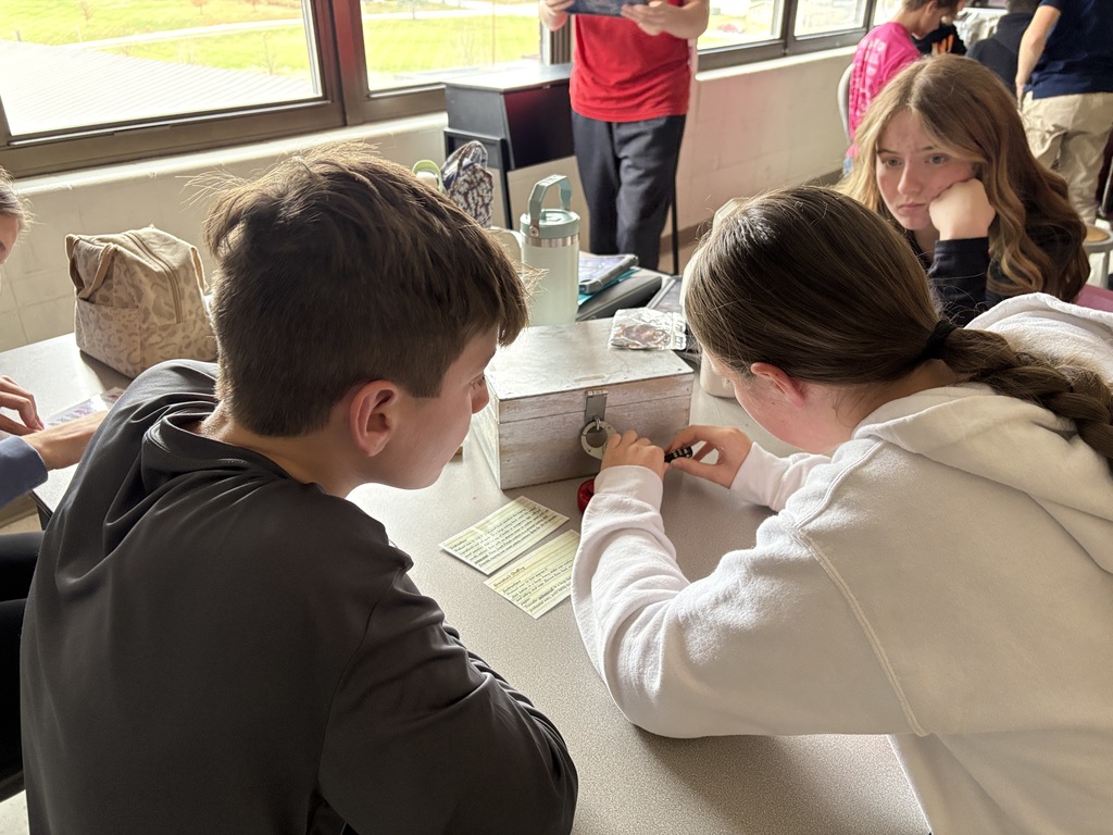 Ms. Morris class used clues to solve puzzles and unlock locks in an escape room like activity