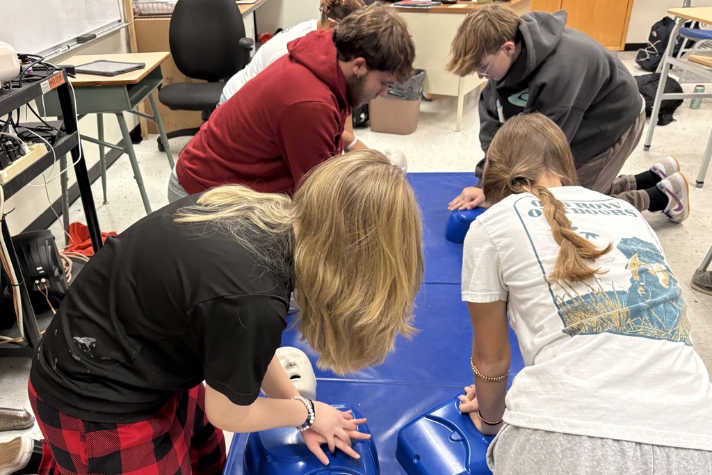 Health students learning life saving Heimlich and CPR