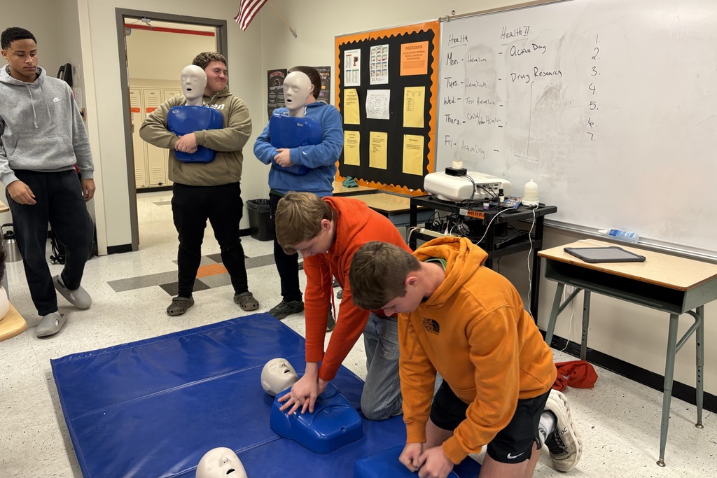 Health students learning life saving Heimlich and CPR