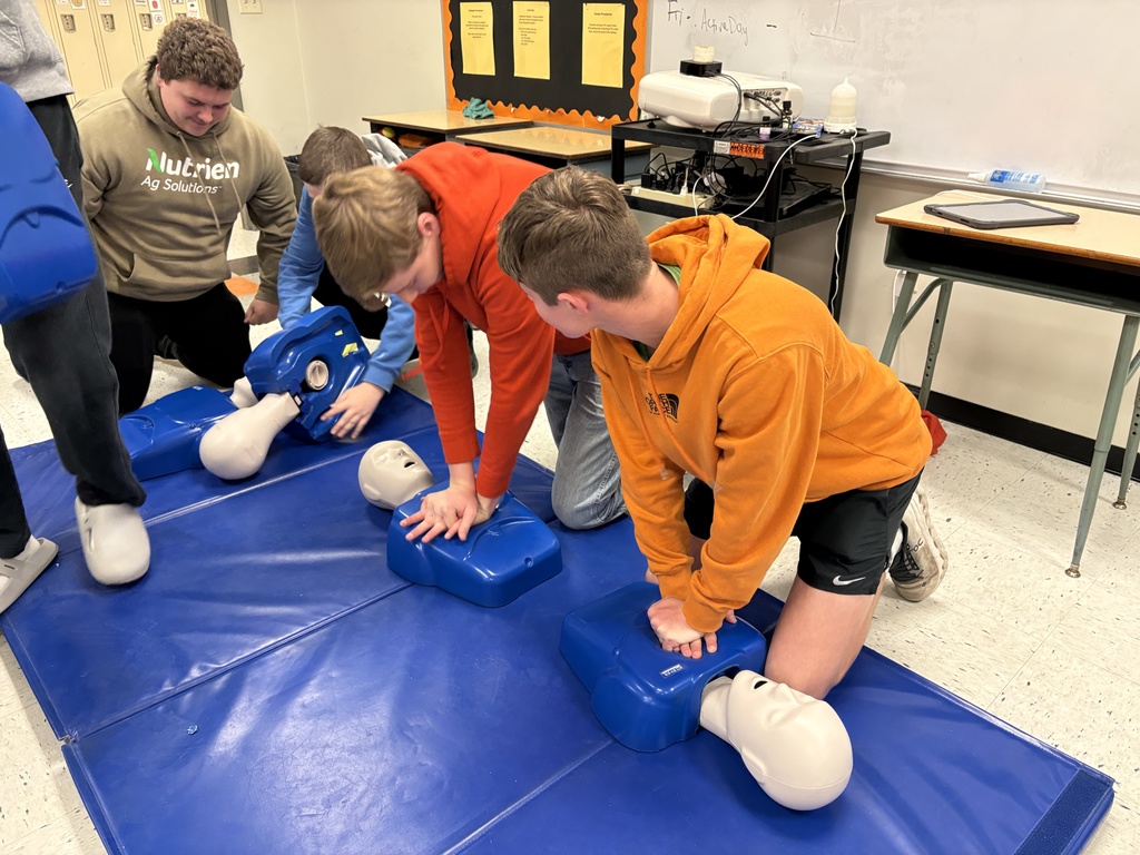 Health students learning life saving Heimlich and CPR