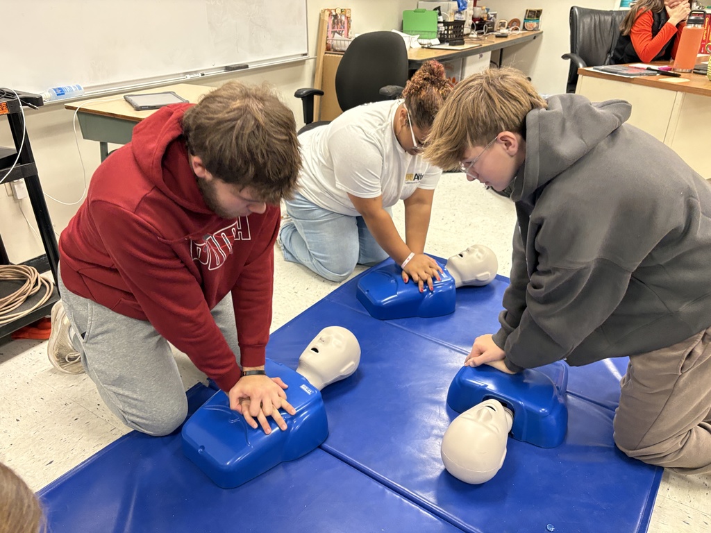 Health students learning life saving Heimlich and CPR