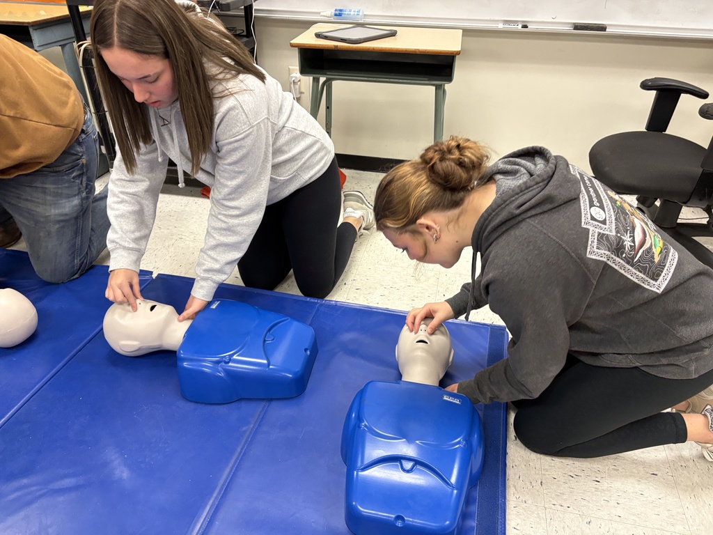 Health students learning life saving Heimlich and CPR