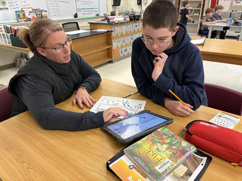 Students in STEM class work on Christmas Around the World display
