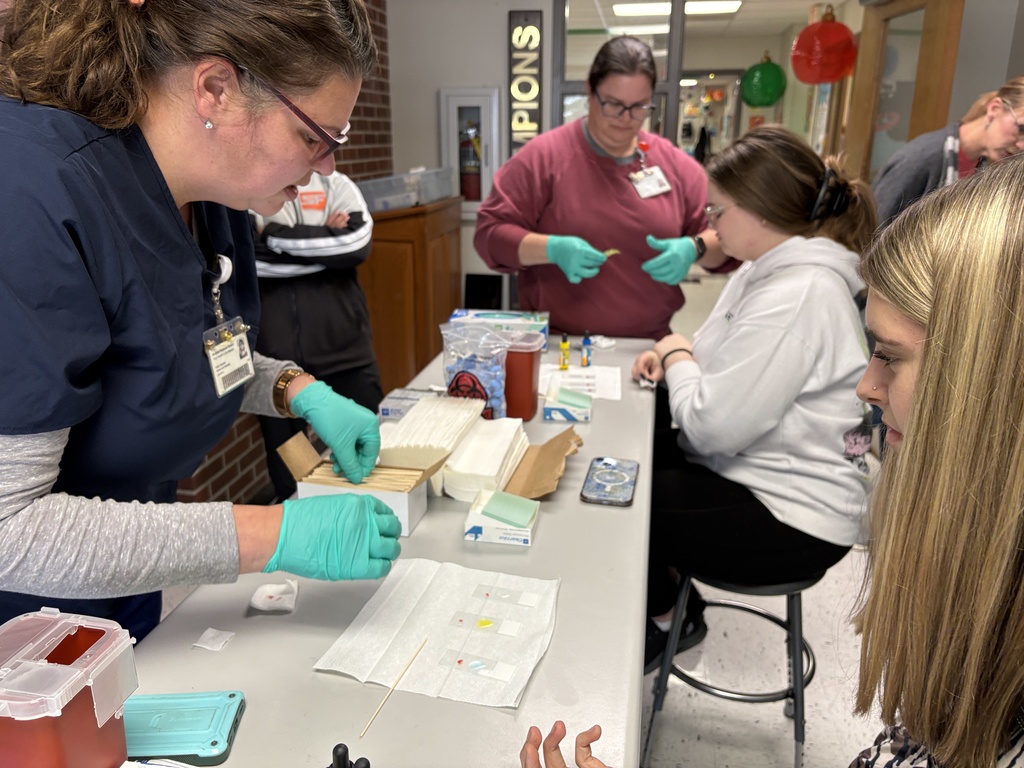 Students performing blood typing lab in science class