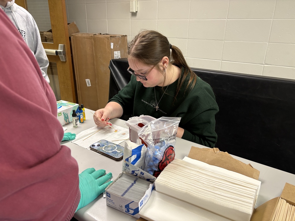 Students performing blood typing lab in science class