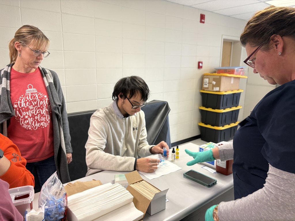 Students performing blood typing lab in science class