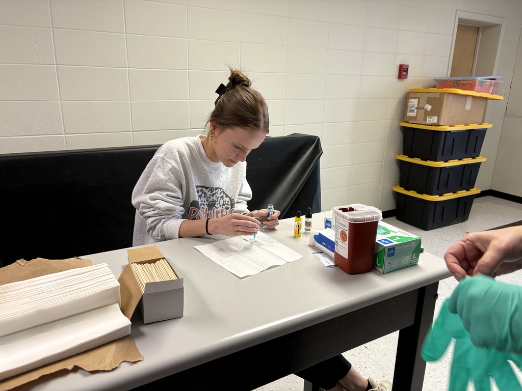 Students performing blood typing lab in science class