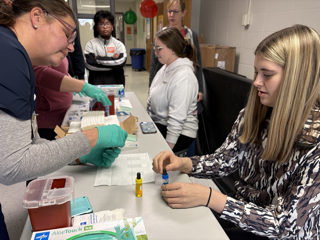 Students performing blood typing lab in science class