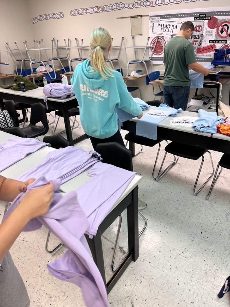 students making shirts for powderpuff homecoming rally