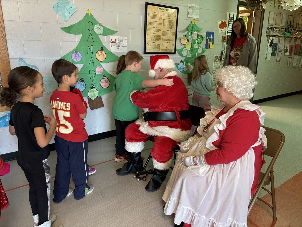 Palmyra Elementary school students in the gym caroling with Santa and Mrs. Claus